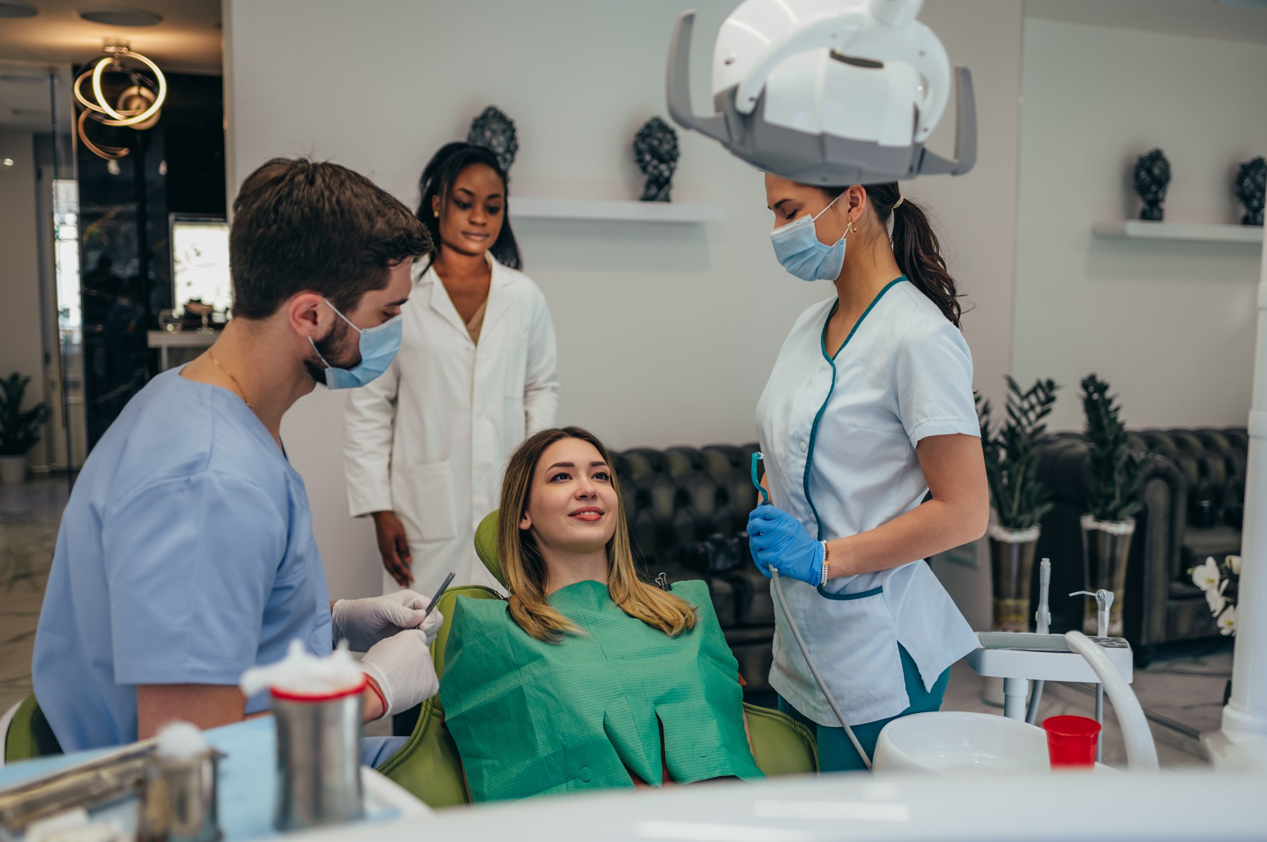 Woman patient in dental clinic being examined by a male dentist